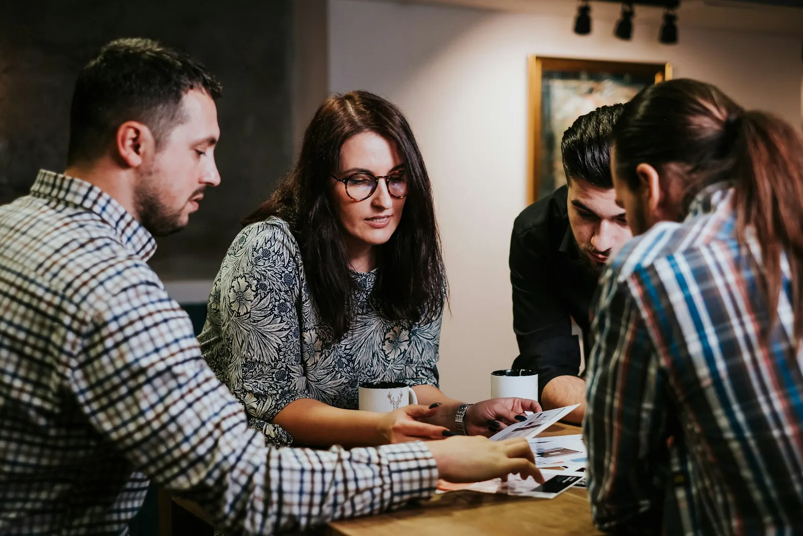 Four people reviewing documents together around a table